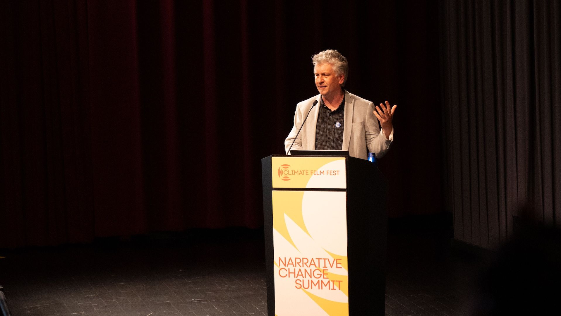 Moritz Stefaner speaking at a Climate Film Fest podium branded "Narrative Change Summit"