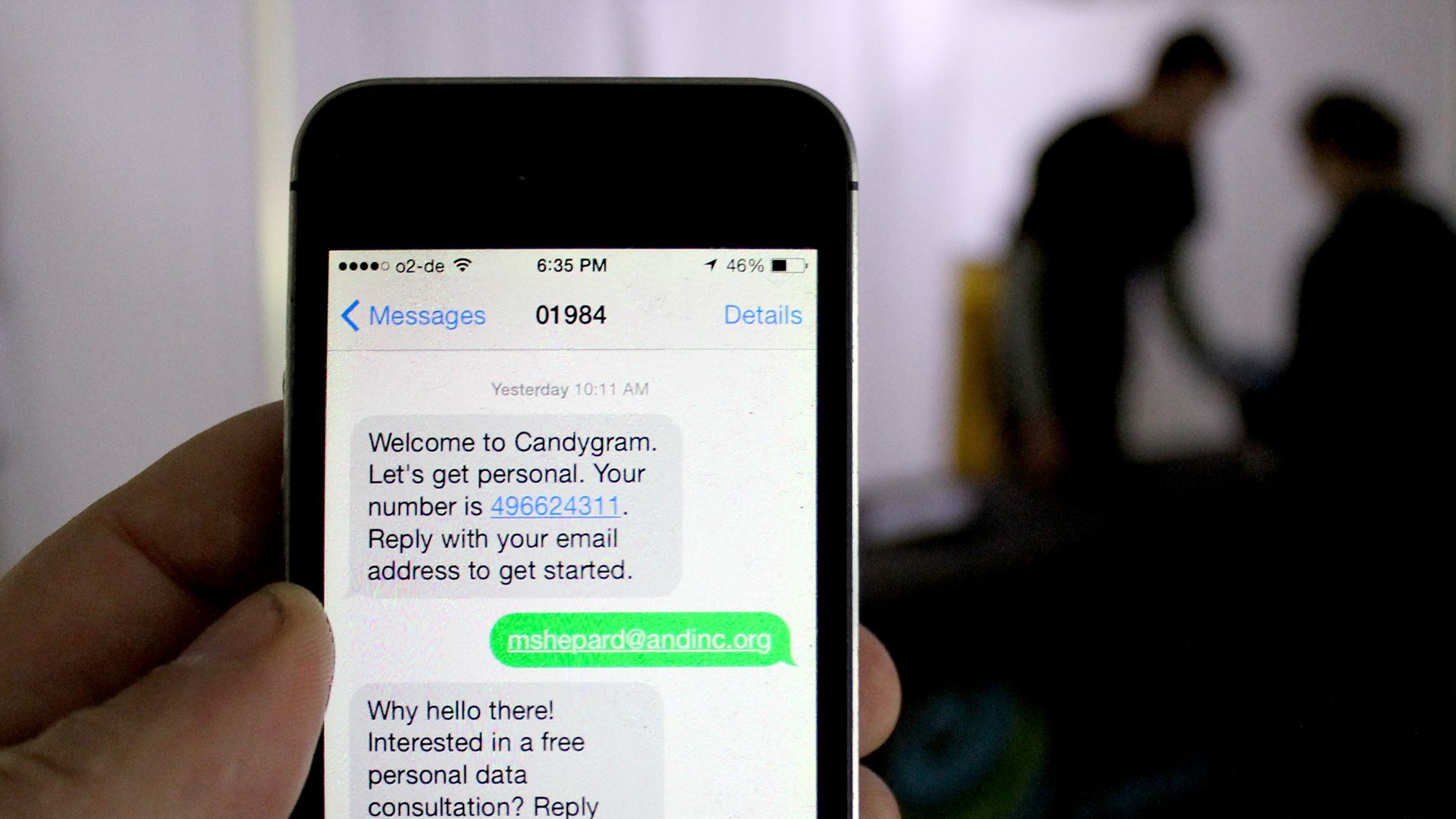 Phone showing an unsolicited Candygram text welcoming the recipient and asking for their email address