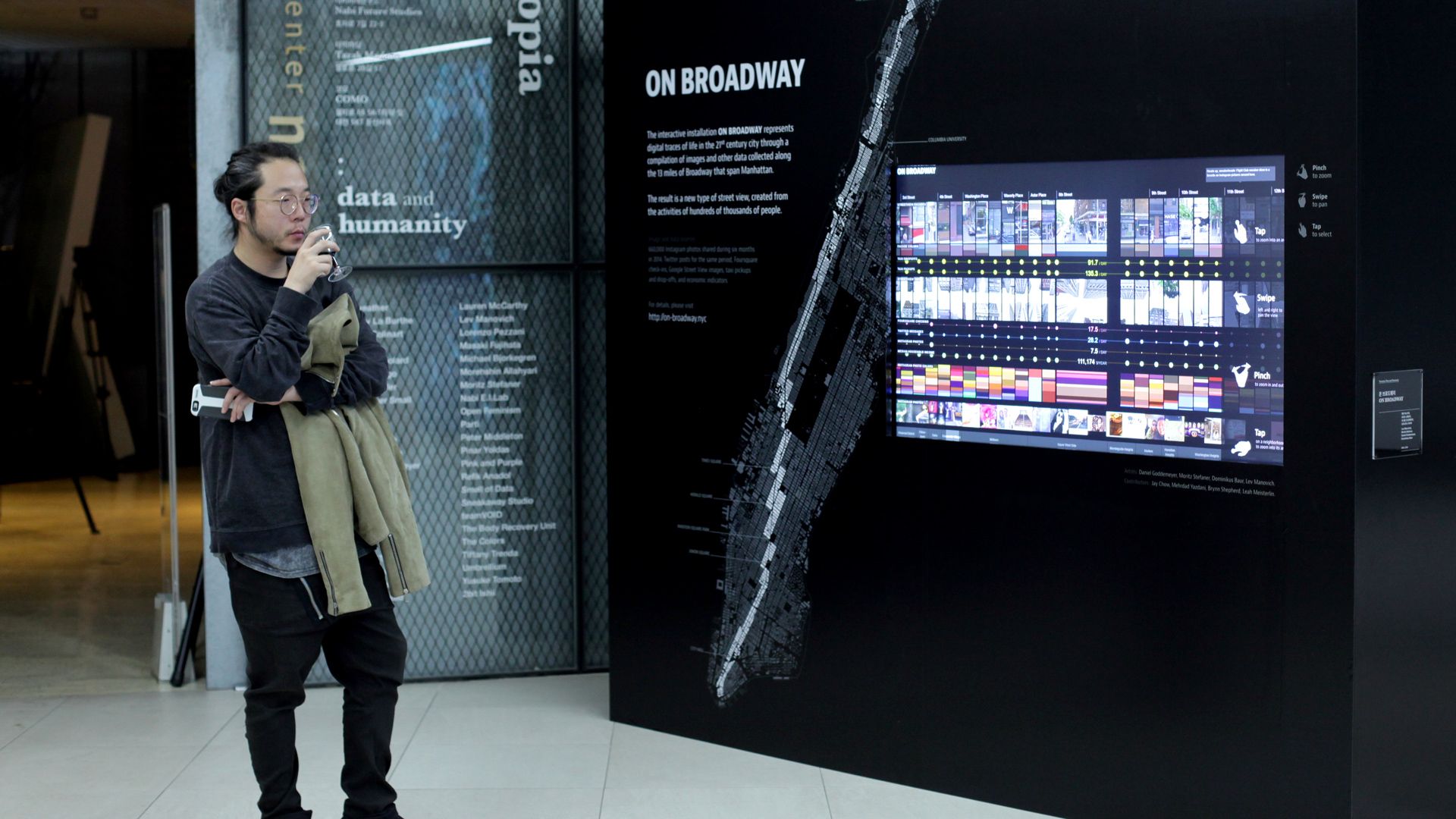 Visitor viewing the On Broadway installation and its Manhattan map at an exhibition in Seoul